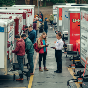 Photo featuring a lineup of U-Haul trucks, showcasing size variations.